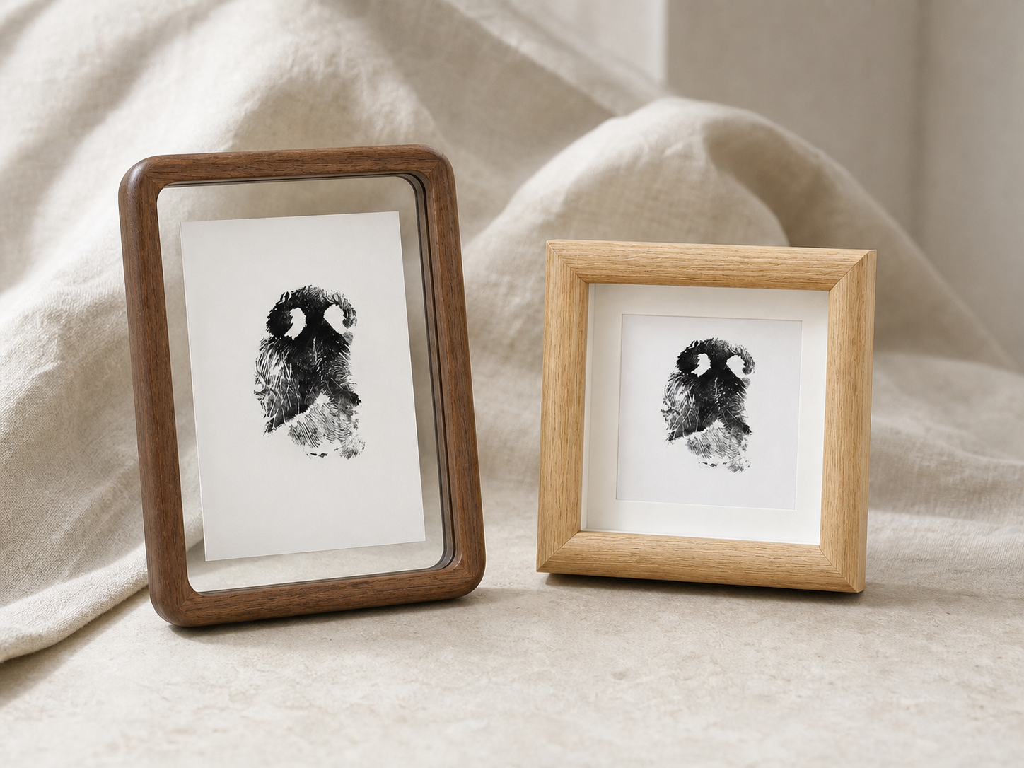 Dark walnut floating frame beside a light oak-finish square shadow box