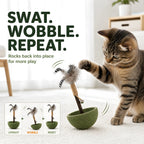 Cat batting the self-righting feather tumbler toy during interactive indoor play