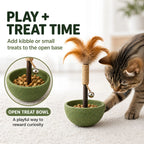 Open cat toy base filled with small treats beside the assembled feather tumbler