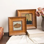 A beautiful example of a pet memorial corner. Premium wood frames arranged on a table with decor, showing how to honor a lost pet stylishly. These frames are sized perfectly for our custom nose print kits, making a thoughtful sympathy gift display.