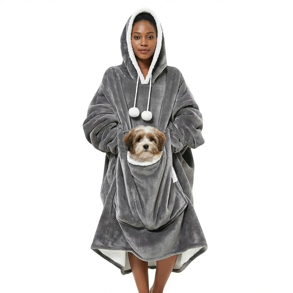Larleaf grey kangaroo wearable blanket modeled by a woman. Features a large front pouch pocket designed to hold a pet, shown here with a cat inside. The oversized hoodie is made of soft fleece with a warm sherpa lining and drawstrings. Main image