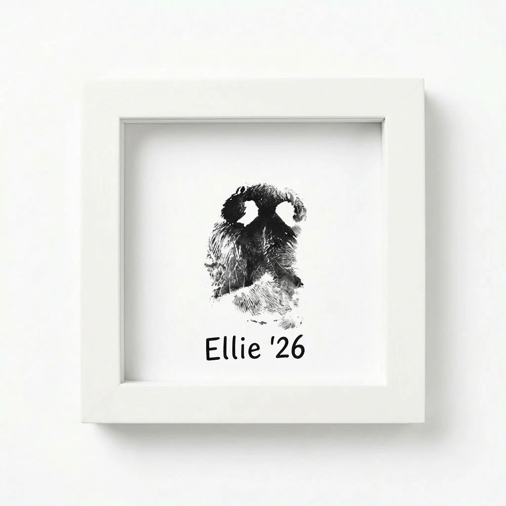 Direct front view of pristine white wooden pet memorial shadow box frame featuring a detailed dog nose print (snout print). Shows custom text example 'Ellie '26' below the ink impression. A pure, minimalist sympathy gift to honor a pet's memory