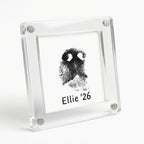 A clear acrylic magnetic frame holding a customized black dog nose print card reading "Ellie '26", attached to a stainless steel refrigerator door. Perfect as a pet memorial keepsake.