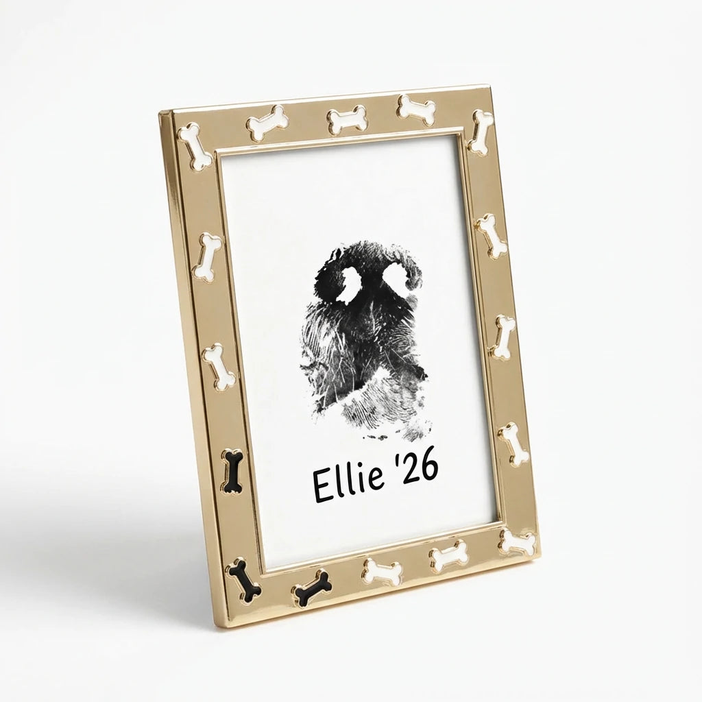 Adorable new puppy gift: Gold metal frame with a decorative dog bone border. Displays a personalized nose impression art 'Ellie 26'. This fun and stylish frame is perfect for framing a favorite photo of a new furry family member.