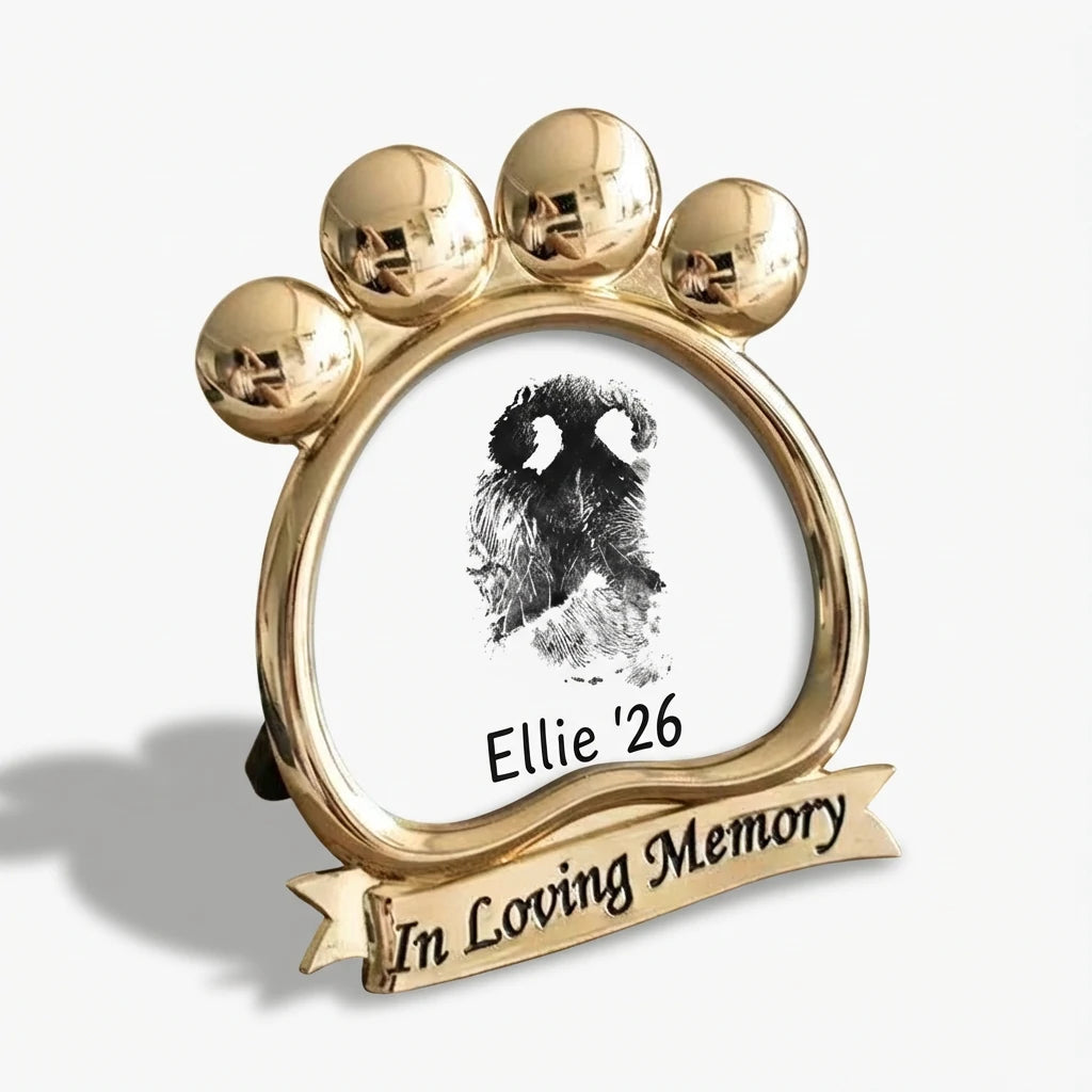 Custom dog nose print art displayed in a gold paw-shaped frame. Features an 'In Loving Memory' inscription on the base. This specialized memorial holder is designed to showcase a unique nose impression. A beautiful way to remember a passed pet. Main image