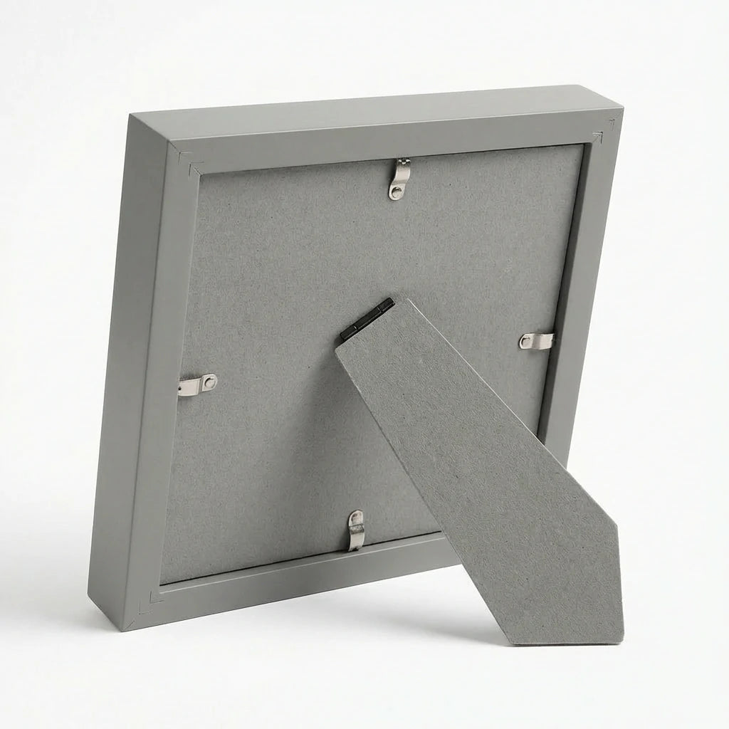 Back view of modern grey pet memorial shadow box frame. Highlights sturdy easel stand for secure tabletop or shelf display. Shows durable backing board and metal turn buttons for easy access to insert pet nose print or photo. Quality construction remembrance gift.