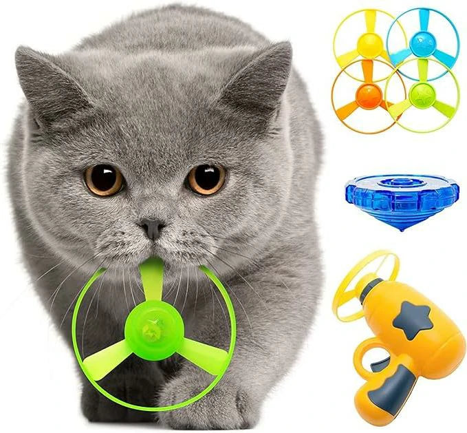 Larleaf yellow pet fetch toy gun displayed with a grey cat holding a flying disc. The set includes a yellow launcher, multiple colored flying saucers, and a light-up gyroscope.