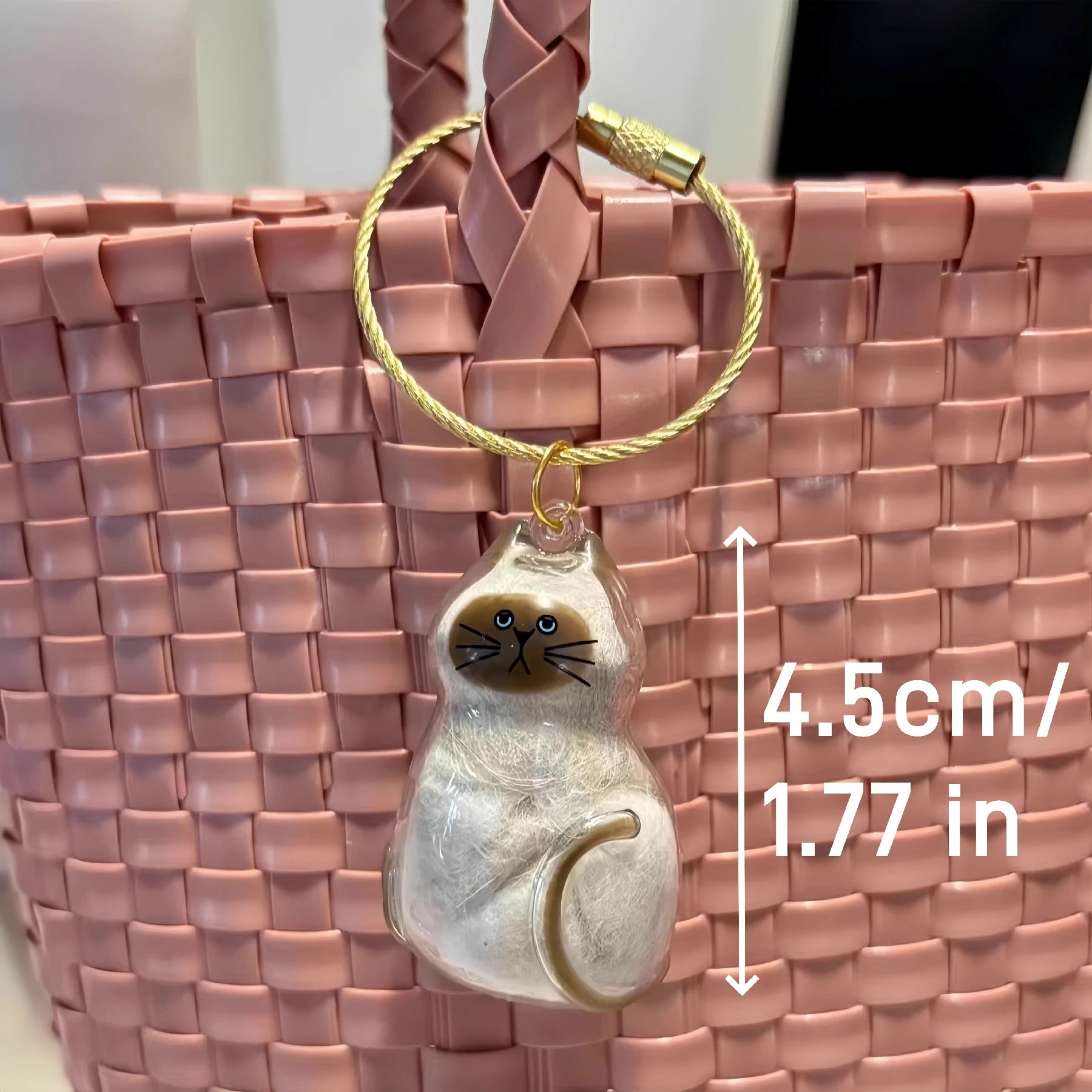 A variety of Larleaf cat-shaped transparent keychains for storing pet fur. Each memorial container features a unique cat face and is shown filled with different colors of fur, representing a heartwarming souvenir for pet owners.