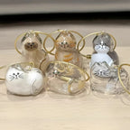 A collection of Larleaf cat-shaped clear keychains designed for pet hair storage. These memorial containers allow pet owners to keep a lock of fur as a souvenir. Features cute cat faces and golden wire loops for hanging.