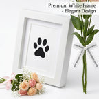 Angled view of premium white wooden pet memorial shadow box frame showing deep display depth. Features a black paw print tribute styled with pastel roses and 'Best Wishes For You' ribbon. An elegant sympathy gift for loss of a beloved dog or cat