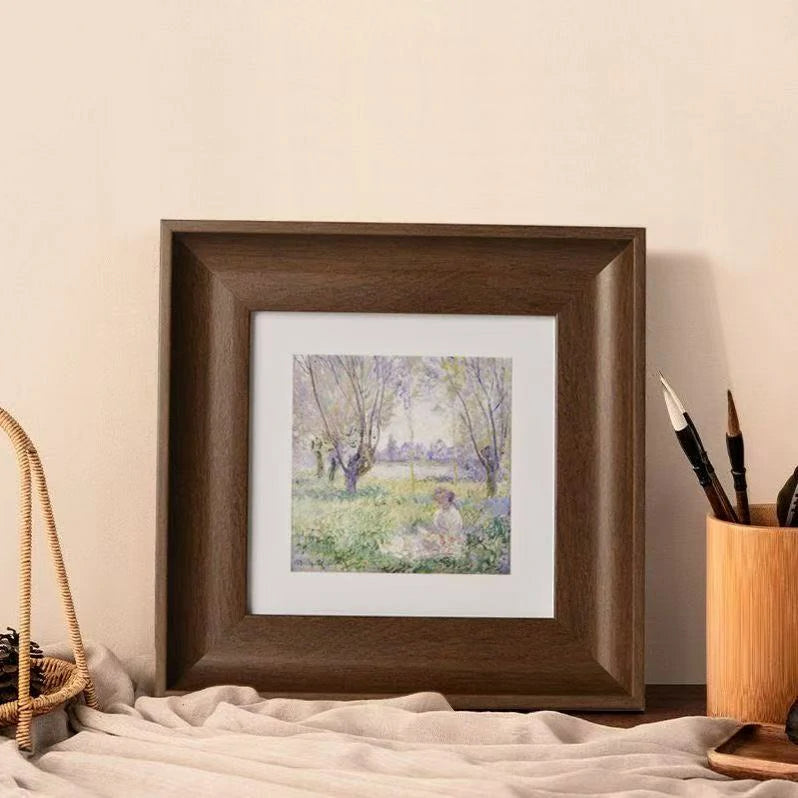 A square wooden frame displayed with paintbrushes and art supplies, suggesting a creative workspace. Perfect for framing DIY projects like custom dog nose prints or paw print art. This walnut-finish frame turns a handmade pet keepsake into gallery art.